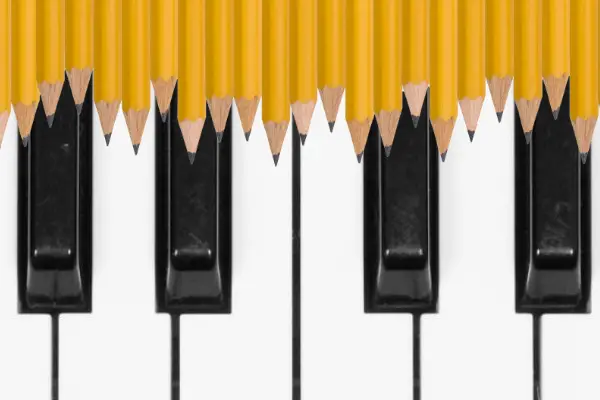 Black and White Piano Keyboard with Music Notes Pencils